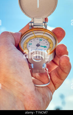 Close up hand holding a compass Stock Photo