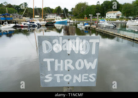 Hand painted sign warning people not to throw stones in Kennebunkport harbor, Maine, USA. Stock Photo