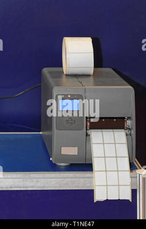 Barcode Label Printer Machine in Warehouse Stock Photo