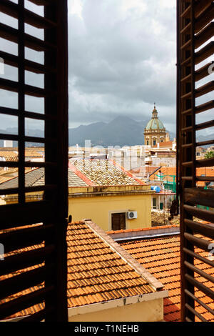 View of the old town of Palermo in Sicily through the open window with shutters, Italy Stock Photo