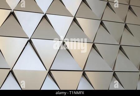 Futuristic Wall of relief metallic triangles. 3d geometric background. Stock Photo