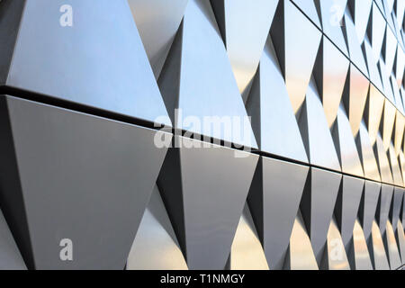 Futuristic Wall of relief metallic triangles. 3d geometric background. Stock Photo