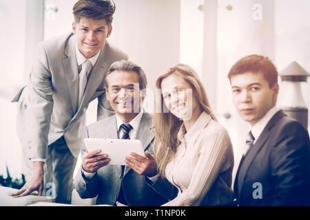 serious business team with tablet computers, documents having discussion in office Stock Photo