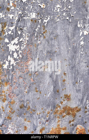 Rusty metal surface with dark blue paint flaking and cracking texture. Rusty metal background. Stock Photo