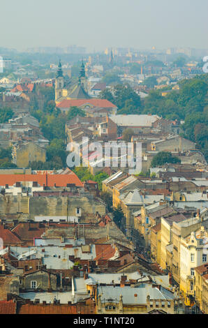 Lviv, Ukraine- September 1, 2018: Long street. Foggy Morning of the City Center from Town Hall Tower. Tiled Roofs of the Old City Stock Photo