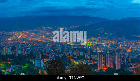 Panoramic cityscape of Medellin city at night (blue hour) located in a valley of the Andes mountain range, Colombia. Stock Photo