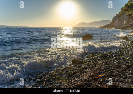 Waves beat on the coastal stones. Stock Photo