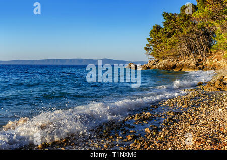 Waves beat on the coastal stones. Stock Photo
