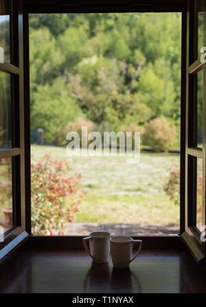 white coffee cups on the windowsill, blur background Stock Photo
