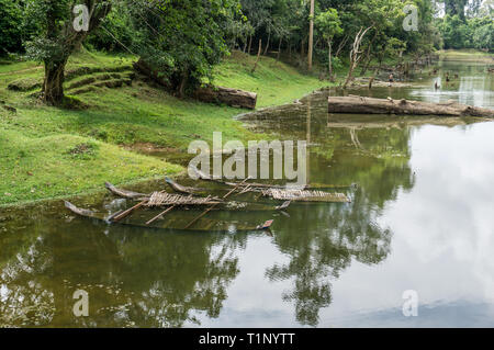 Sunken old boats on the artificial moat surrounding the Bayon tempe near Angkor Wat Stock Photo