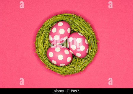 colored easter eggs in a green nest Stock Photo