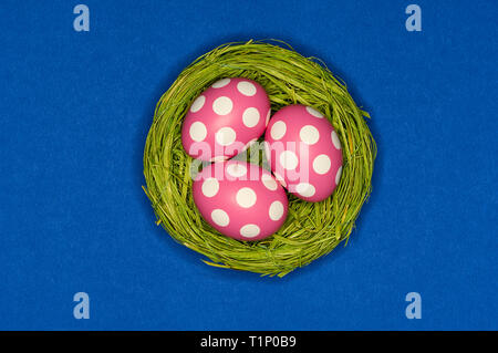colored easter eggs in a green nest Stock Photo