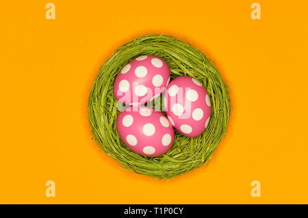 colored easter eggs in a green nest Stock Photo