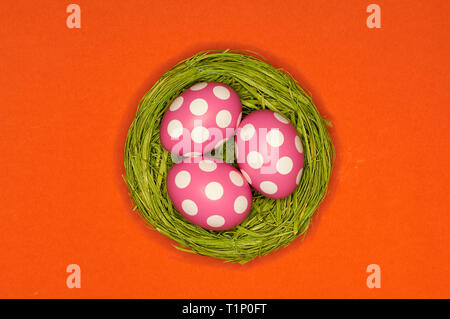 colored easter eggs in a green nest Stock Photo