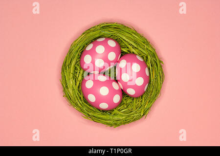 colored easter eggs in a green nest Stock Photo