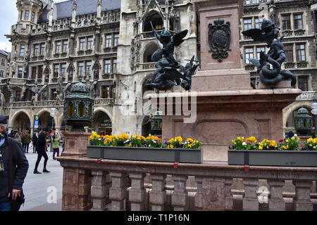 Old lamp and statues on a column in front of the city hall in munich Stock Photo