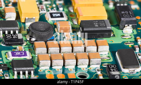 Integrated circuits. Surface mount technology. Electronic components. Printed circuit board detail. Inner computer hard drive electronics. Chips, coil. Stock Photo