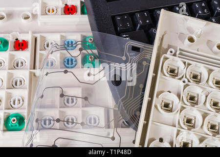 Old computer keyboards. Plastic waste recycling. Printed flex circuit membrane. Push buttons. Dismantled PC parts pile. Rubber dome switches, PCB, key. Stock Photo