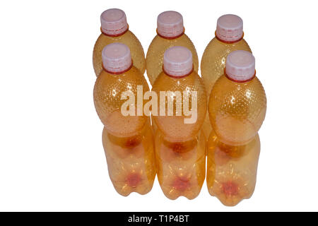 Orange plastic bottles group. Isolated on white background. Empty used beverage packagings. Caps detail. Waste sorting. Environmental contamination. Stock Photo