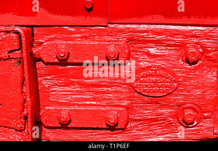 Red painted wagon boards and plaque Stock Photo