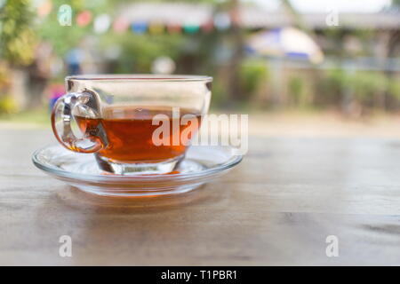 Hot tea in a cup on wooden table in the coffee shop, image with copy space. Stock Photo