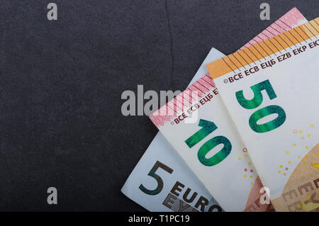 Euro bills. Different denominations on a gray background. 5, 10 50 euros Stock Photo