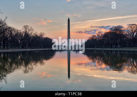 View of Washington Monument at sunrise with reflection on the Lincoln Memorial Reflecting Pool in Washington DC, USA Stock Photo