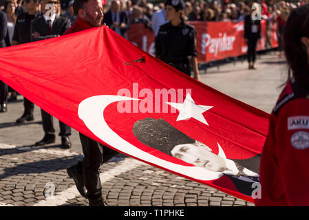 Izmir, Turkey - October 29, 2018: Turkish flag with Mustafa Kemal Ataturk photo on it and a clove is about to fall on to the flag. Stock Photo