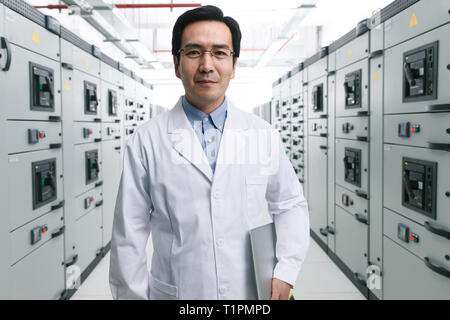 Technical personnel in the voltage room work Stock Photo