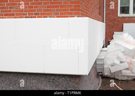 white polystyrene insulation on a brick wall Stock Photo