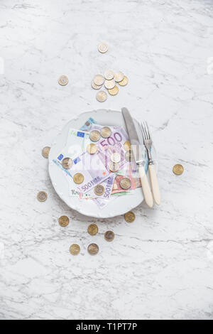 Top of view full plate of euro money coins and banknotes. Stock Photo