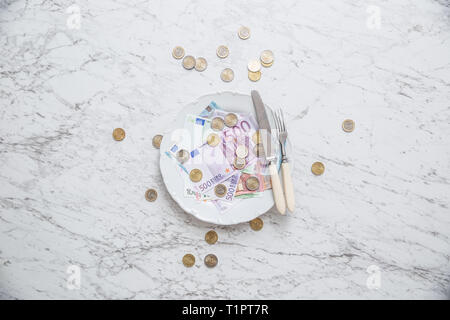Top of view full plate of euro money coins and banknotes. Stock Photo