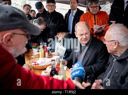 28 March 2019, Brandenburg, Eberswalde: Olaf Scholz (SPD), Federal Minister of Finance, talks with citizens in Eberswalde at the start of the tour of the SPD parliamentary group under the motto 'Come to hear'. Faction members and federal ministers tour Brandenburg, Mecklenburg-Western Pomerania, Saxony-Anhalt, Thuringia, Saxony, Bavaria and Baden-Württemberg. Until September a bus travels every week to a different federal state. Photo: Kay Nietfeld/dpa Stock Photo