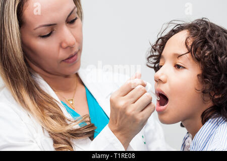 Doctor giving a child homeopathic medicine Stock Photo