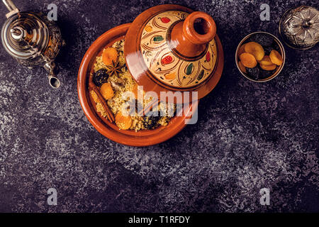 Traditional moroccan tajine of chicken with dried fruits and spices, top view. Stock Photo
