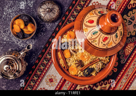 Traditional moroccan tajine of chicken with dried fruits and spices, top view. Stock Photo