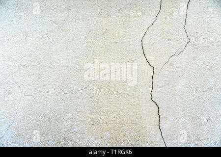 Plastered surface cracked. Cracked wall white background texture Stock Photo