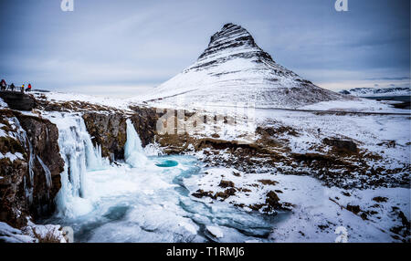 Frozen famous waterfall near mountain in Iceland Stock Photo