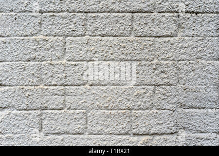 plastered brick wall in yellow and gray Stock Photo