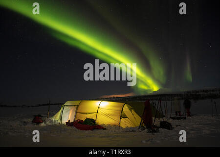 Aurora borealis over a winter ski touring tent. Finnmarksvidda Plateau. Finnmark, Arctic Norway.