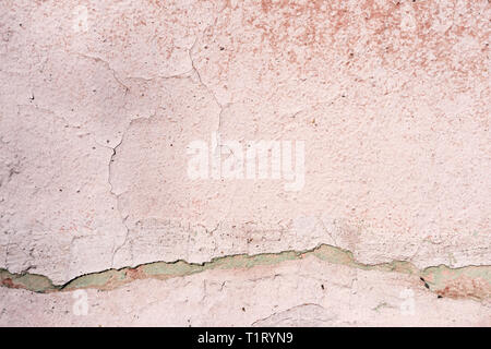Old wall covered with cracked paint closeup as background and texture Stock Photo