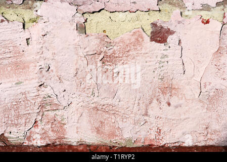 Old wall covered with cracked paint closeup as background and texture Stock Photo