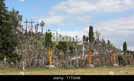 Visitors on the Hill of Crosses in Lithuania Stock Photo