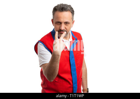 Angry supermarket or hypermarket employee supervisor pointing at eyes as looking at you gesture isolated on white background Stock Photo