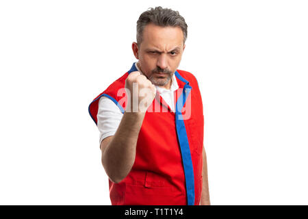 Hypermarket or supermarket male employee with angry expression showing fist as getting ready for fight isolated on white background Stock Photo