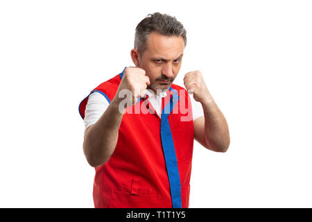 Mad supermarket or hypermarket male employee threatening with fists as preparing to fight concept isolated on white studio background Stock Photo