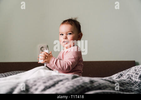 Little child's hand playing with power socket, closeup Stock Photo