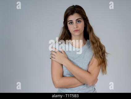 Portrait of young sad woman, serious and concerned crying and feeling worried and depressed isolated on neutral background. In People human expression Stock Photo