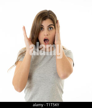 Beautiful young blond woman with happy face pointing and making surprised gestures and looking at something shocking and good. Human facial expression Stock Photo