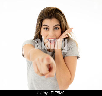Beautiful young blond woman with happy face pointing and making surprised gestures and looking at something shocking and good. Human facial expression Stock Photo